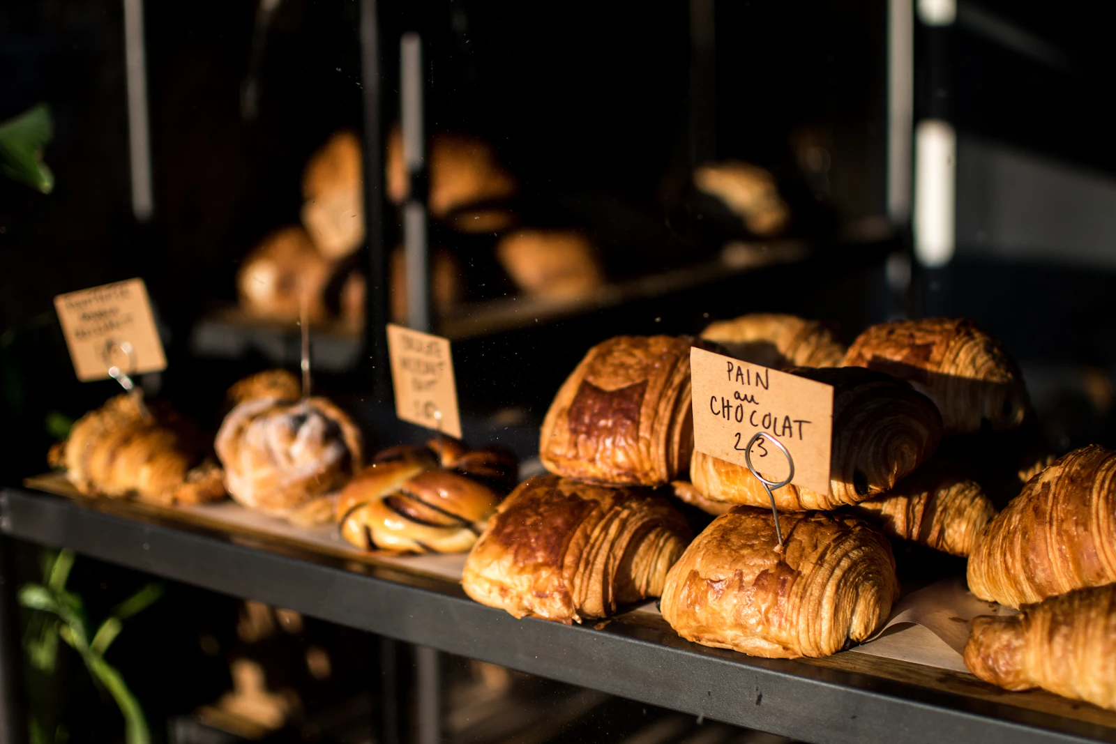 Golden croissants on a dark shelf